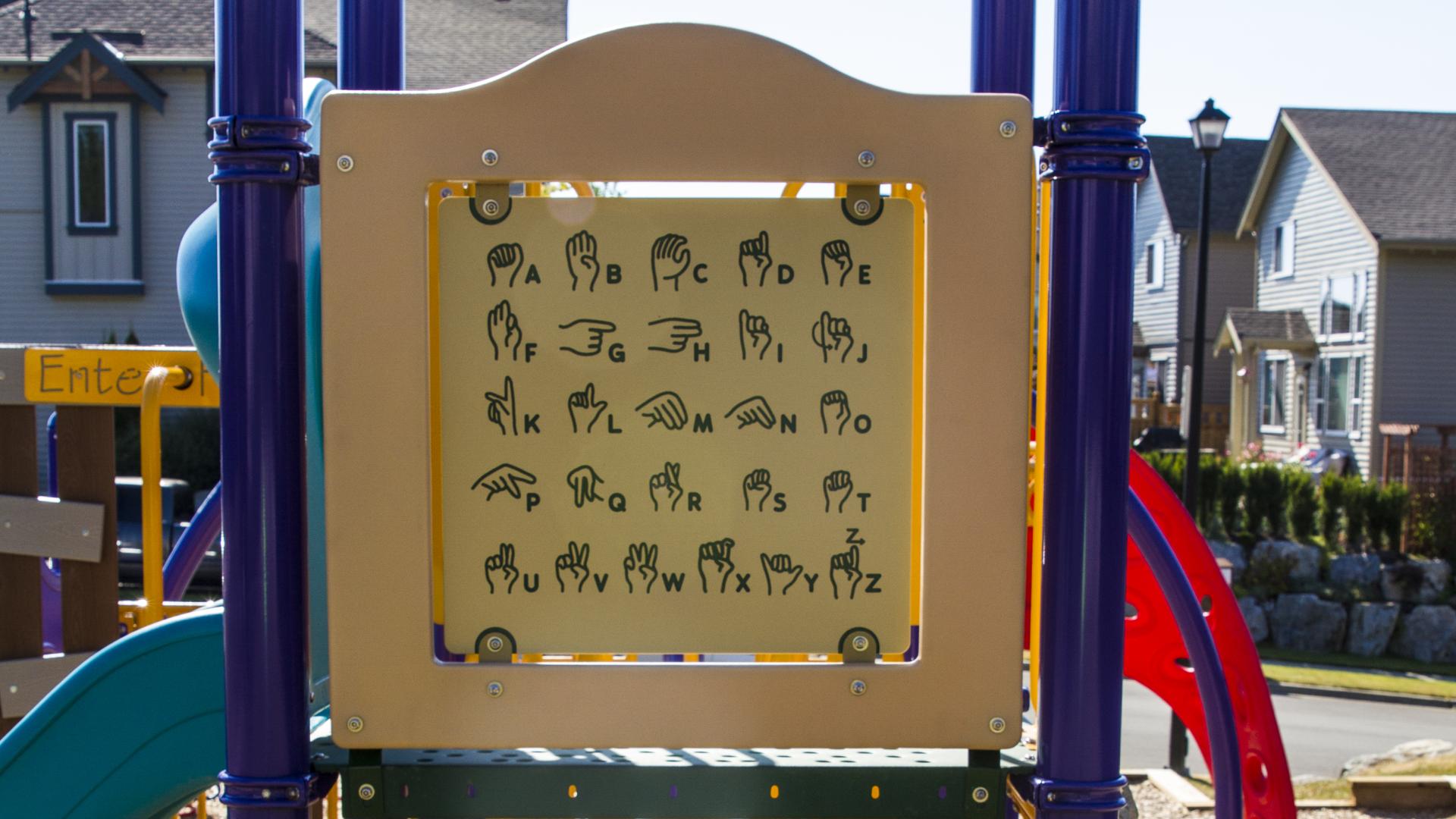 The walls of the playground structure have interactive elements to them.